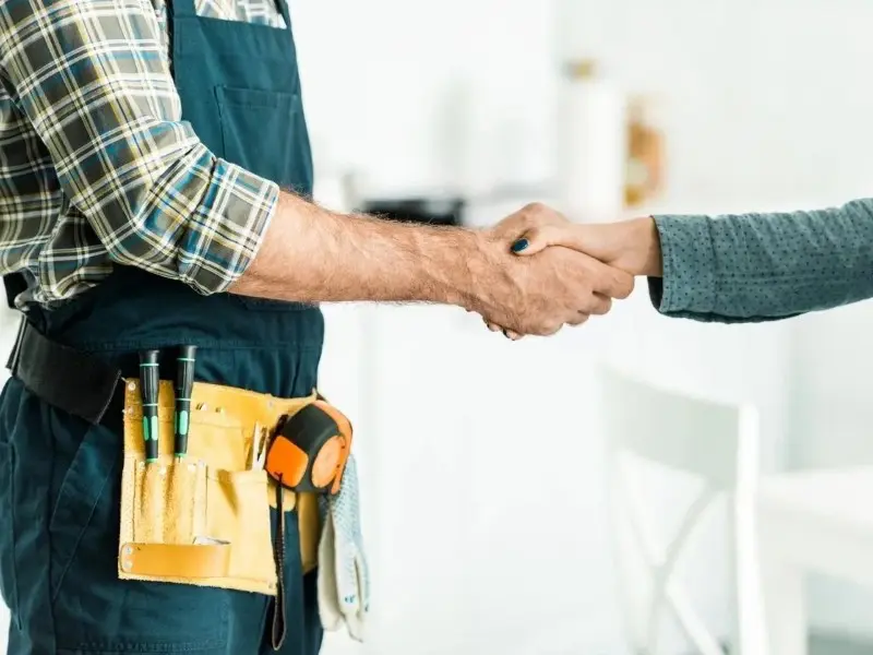 Two men shaking hands in a room.