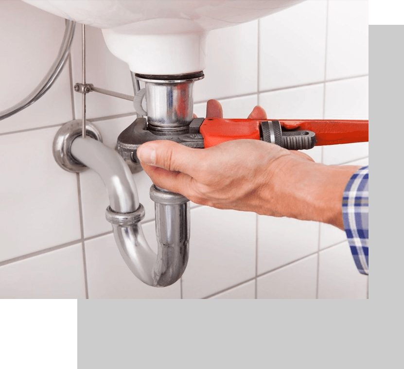 A person is fixing the pipes of a bathroom.